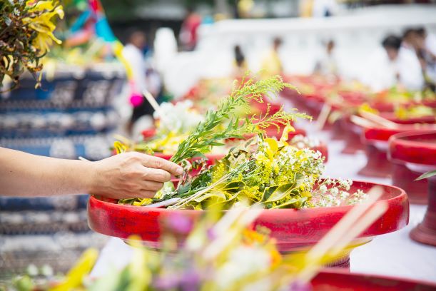 asian-man-holding-fresh-yellow-flowers-participation-local-traditional-buddhist-ceremony-people-with-religion-relationship